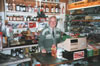Grandad behind the counter in his shop